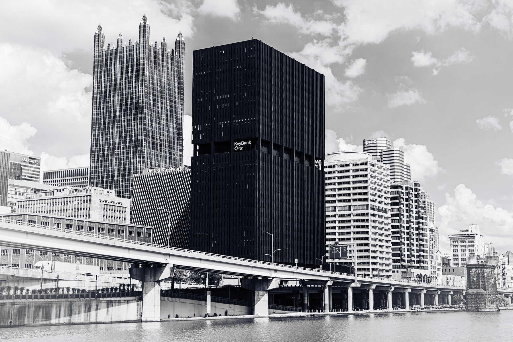 Black and white view of Pittsburgh's Gateway Center towers and a bridge over the Allegheny River