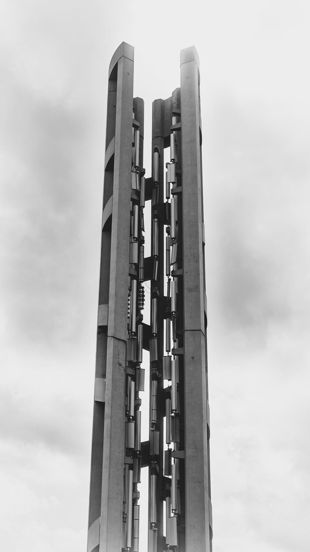 A tight, straight-on view of the Tower of Voices at the Flight 93 National Memorial under a pale sky